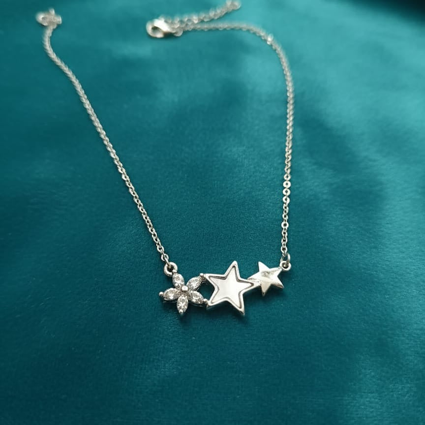 Silver necklace with star and floral pendant