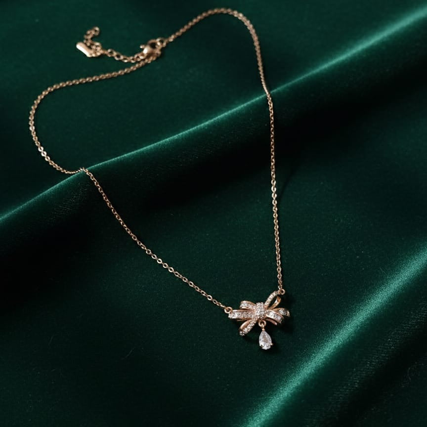 Gold necklace with a bow pendant 