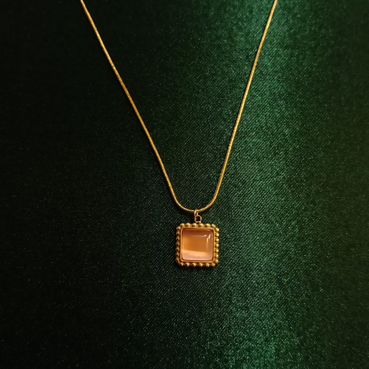 Gold necklace with a square pendant  