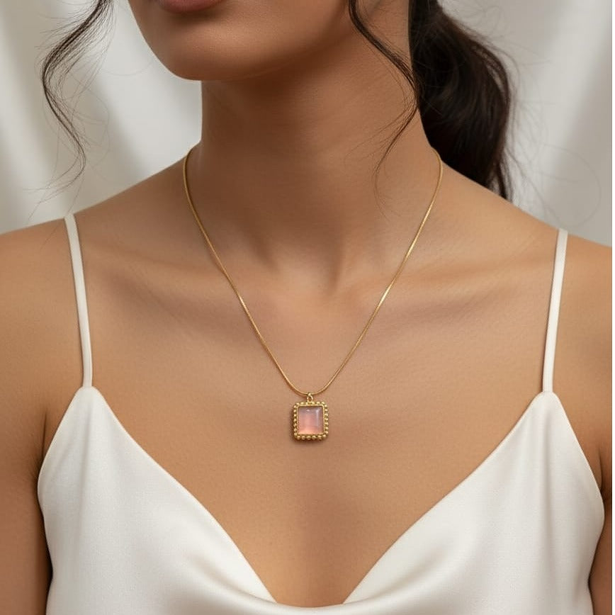  a gold necklace with a pendant  