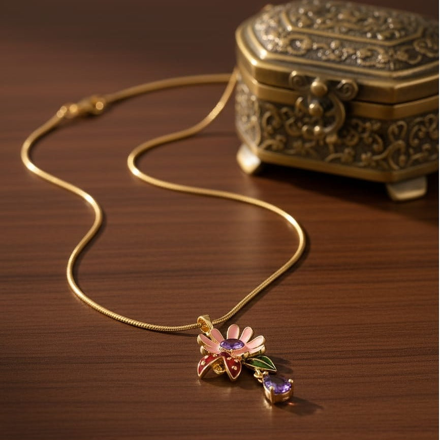 Gold necklace with a floral pendant on a wooden surface